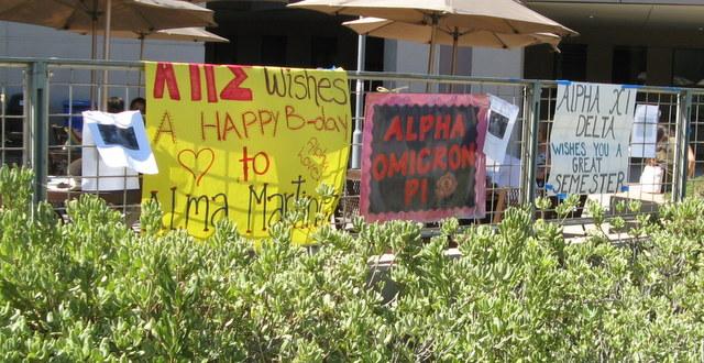 Recruitment signs for on-campus sororities, including the new chapter of Alpha Omicron Pi, center.