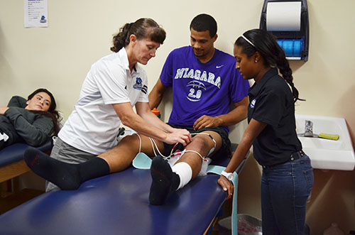Athletic trainer Michelle Hamilton works on a student