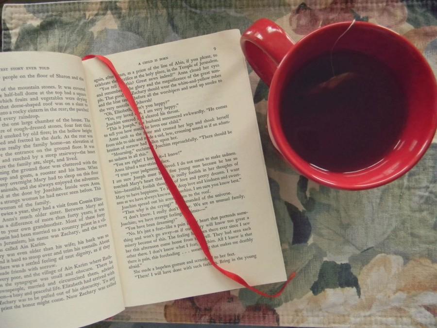 Photo of an open book next to a cup of tea