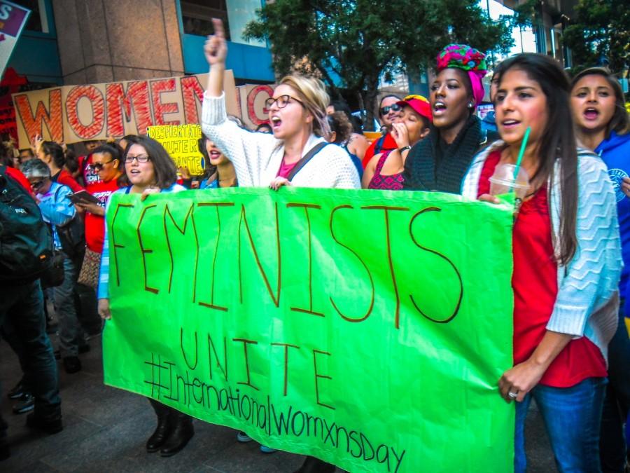 Members of CSUSM's Feminists Unite group march on International Women's Day.