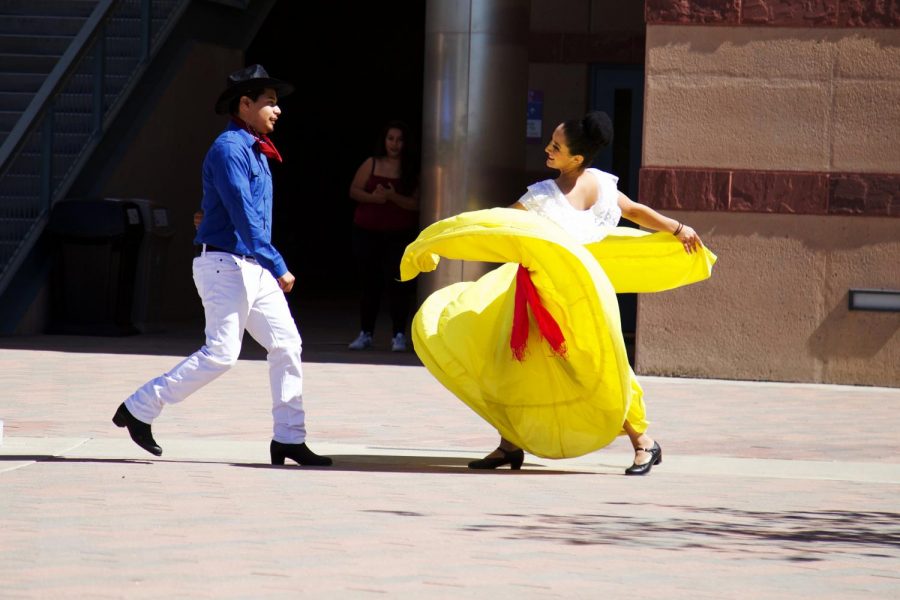 Saul Rojas and Lorena Santiago performing a duet called El Coyote on Oct. 5 in front of University Hall.