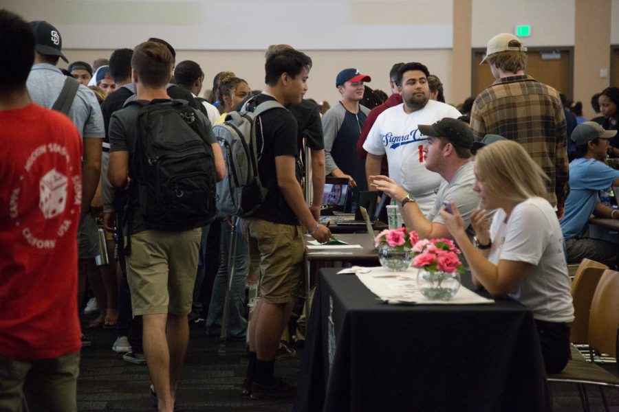 On September 4, students shuffle around the packed USU ballroom to engage with clubs and to learn about university resources.