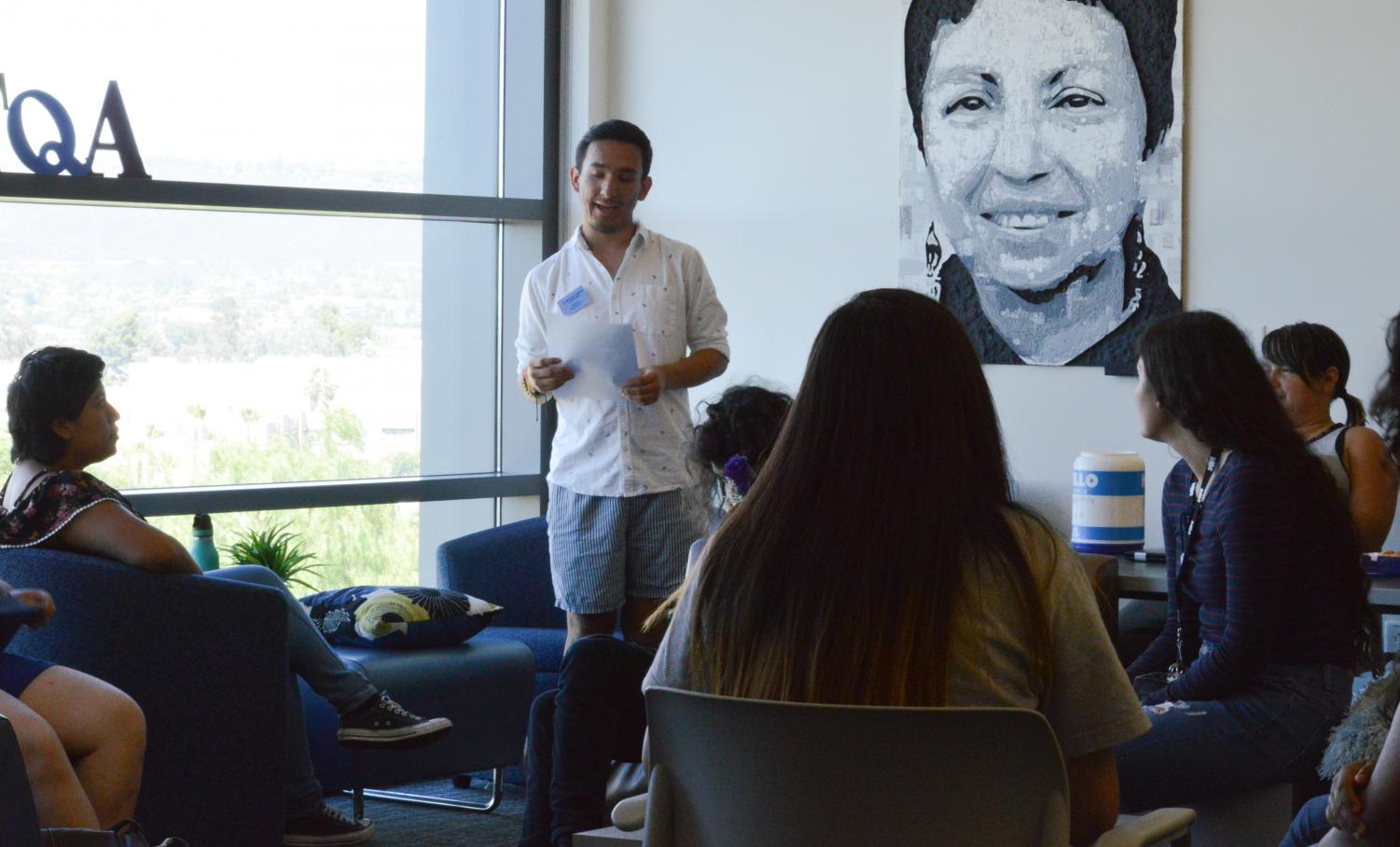 In the LBGTQIA Pride Center, host, Moises Aguilar, welcomes new and old students back to campus with a mixer on August 3.