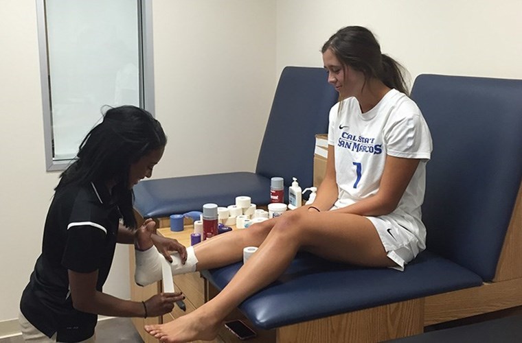 CSUSM sports medicine intern assists an athlete. 
