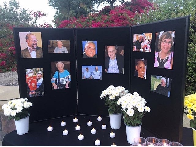The display at the candlelight vigil commemorates the victims of recent shootings.