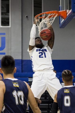 Khalil Fuller dunks the basketball during a game against San Diego Christian on Nov. 13.