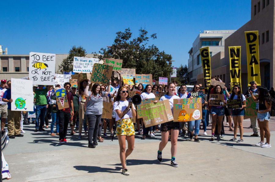 Estefania Fraticelli (left) and Lindsey Cain (right) lead protestors in a solidarity march on Sept. 24.