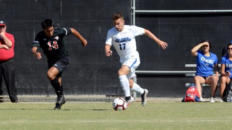 Parker Hodges dribbles past East Bay's Jonathan Garcia.