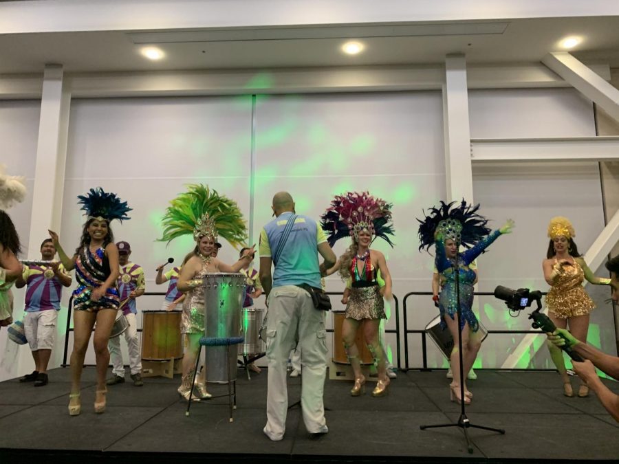 Dancers on stage alongside the Super Sonic Samba School.