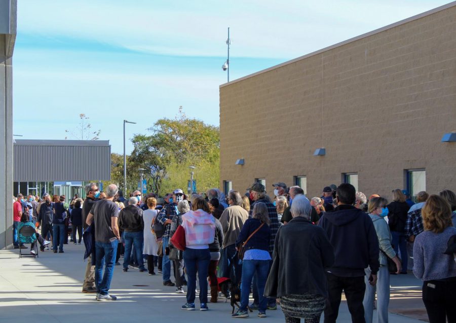 People wait in line to get a COVID-19 vaccine at the CSUSM Sports Center on Jan. 31.