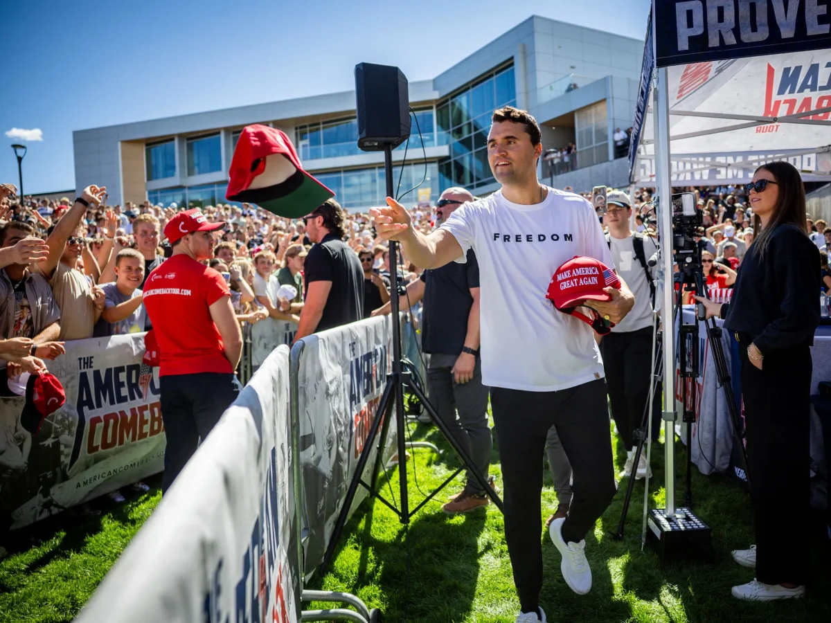 Charlie Kirk on the day of his assassination, handing out MAGA hats.